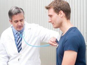 a doctor using a stethoscope on a man